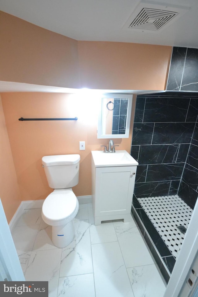 bathroom with toilet, vanity, visible vents, marble finish floor, and a shower stall