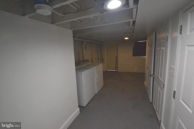 hall with concrete flooring and washing machine and clothes dryer