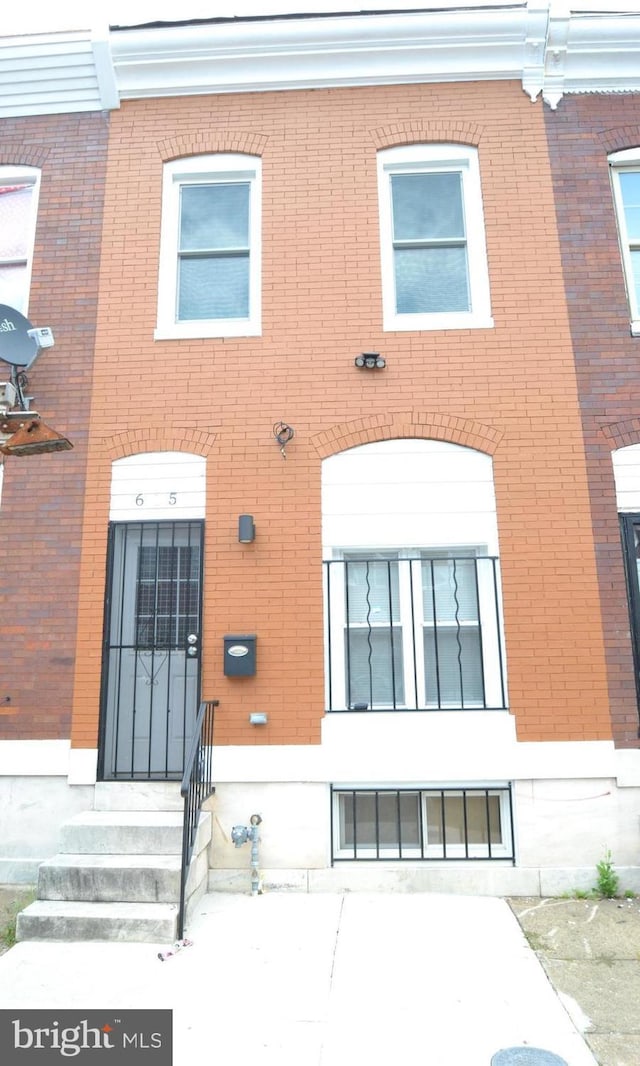 view of front of property featuring entry steps and brick siding