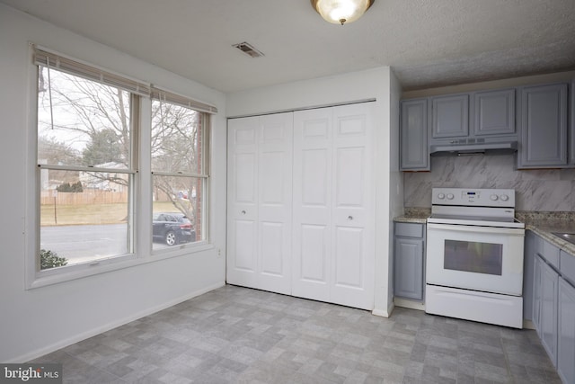 kitchen with light floors, white range with electric cooktop, gray cabinets, visible vents, and under cabinet range hood