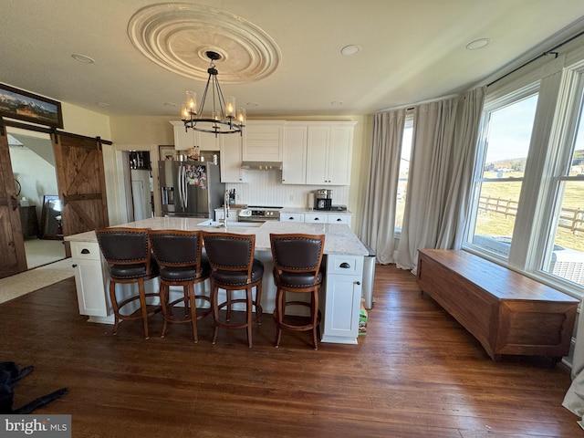 374 Finley Rd, Raphine, VA 24472 - kitchen with a barn door, a wealth of natural light, appliances with stainless steel finishes, and a center island with sink