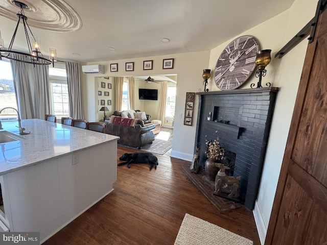 374 Finley Rd, Raphine, VA 24472 - living room with a wealth of natural light, baseboards, dark wood-style floors, and a wall mounted AC