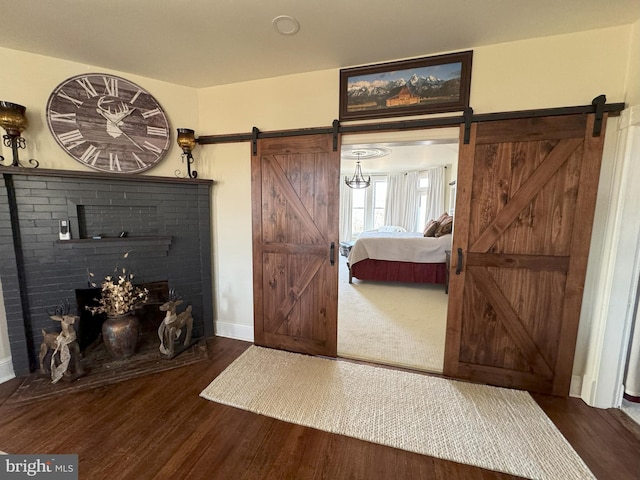 374 Finley Rd, Raphine, VA 24472 - bedroom with baseboards, wood finished floors, and a barn door