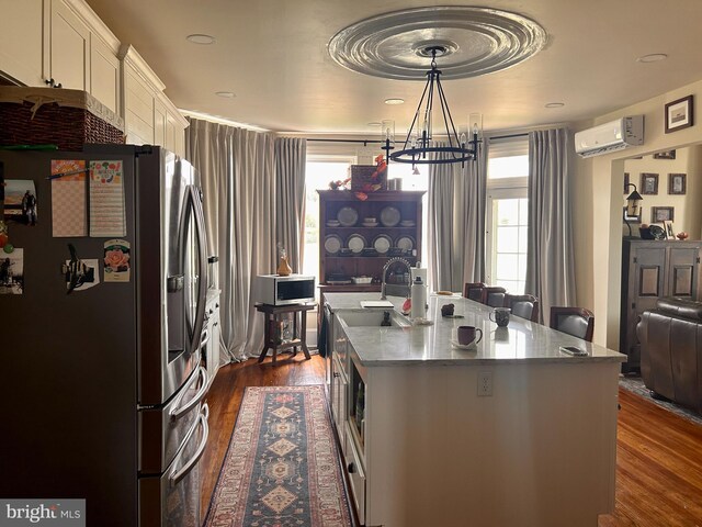 374 Finley Rd, Raphine, VA 24472 - kitchen with a wall mounted air conditioner, a sink, a healthy amount of sunlight, stainless steel refrigerator with ice dispenser, and dark wood-type flooring