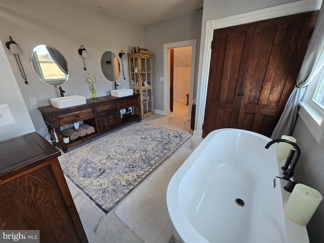 374 Finley Rd, Raphine, VA 24472 - bathroom featuring a sink, marble finish floor, double vanity, a freestanding bath, and baseboards