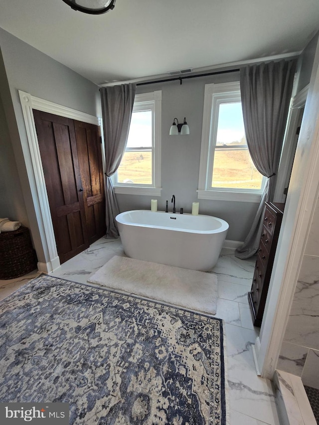 374 Finley Rd, Raphine, VA 24472 - bathroom featuring a freestanding bath, marble finish floor, and baseboards