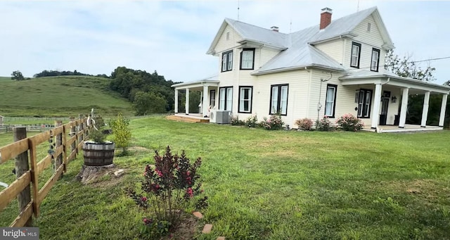 374 Finley Rd, Raphine, VA 24472 - view of property exterior with central AC unit, fence, a yard, and covered porch
