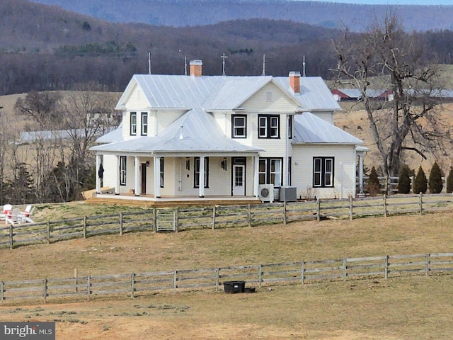 374 Finley Rd, Raphine, VA 24472 - view of front facade featuring central AC unit, a mountain view, a chimney, covered porch, and fence