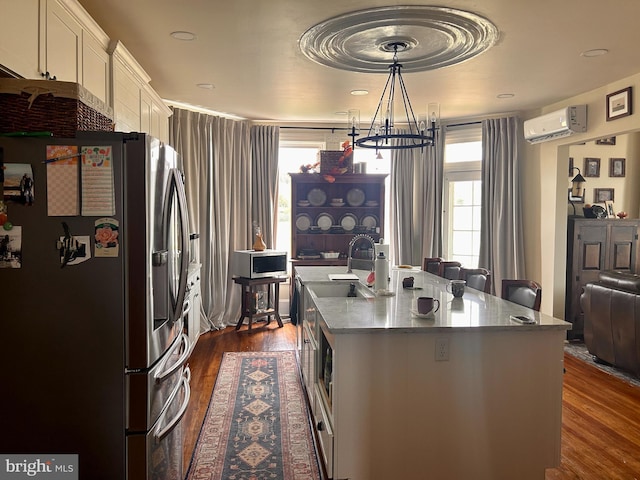 374 Finley Rd, Raphine, VA 24472 - kitchen with a wall mounted air conditioner, a sink, a healthy amount of sunlight, stainless steel refrigerator with ice dispenser, and dark wood-type flooring
