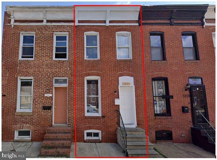 view of property featuring entry steps and brick siding