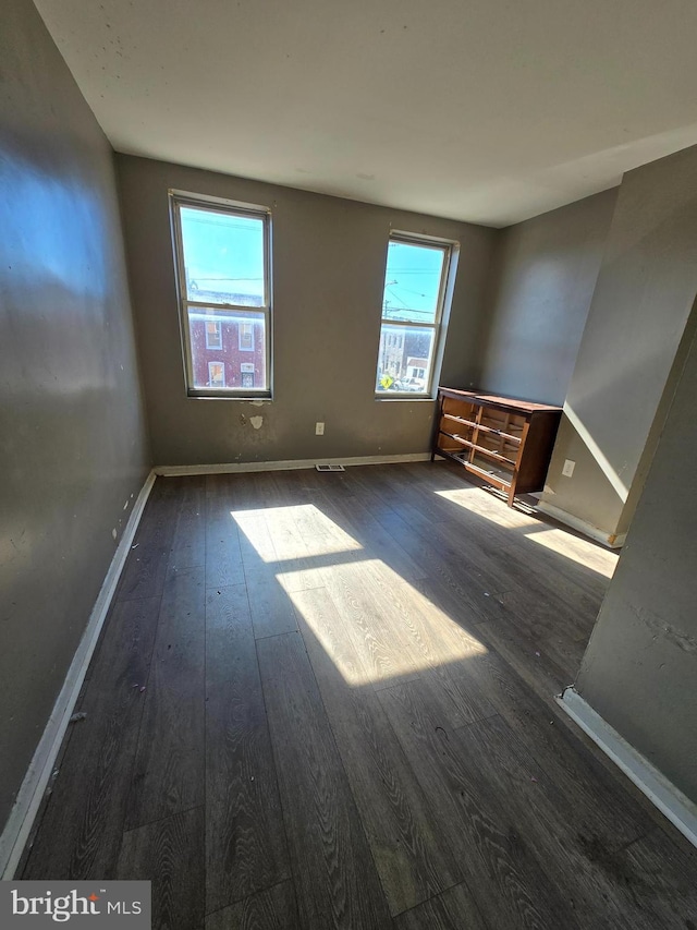 interior space with hardwood / wood-style floors and baseboards