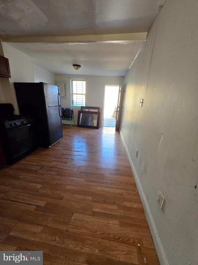 interior space featuring wood finished floors and baseboards