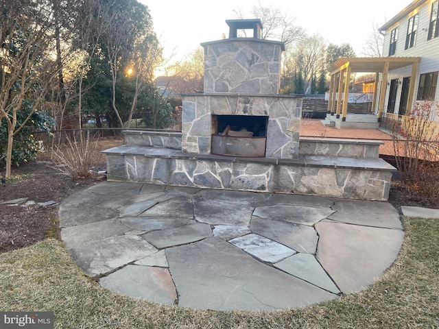 view of patio with an outdoor stone fireplace