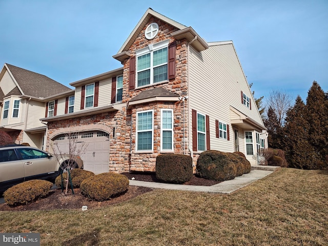 view of front of home with a garage, stone siding, and a front yard