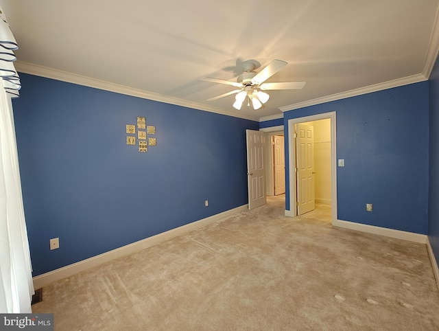 unfurnished bedroom featuring a ceiling fan, light carpet, crown molding, and baseboards