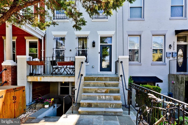 doorway to property featuring brick siding