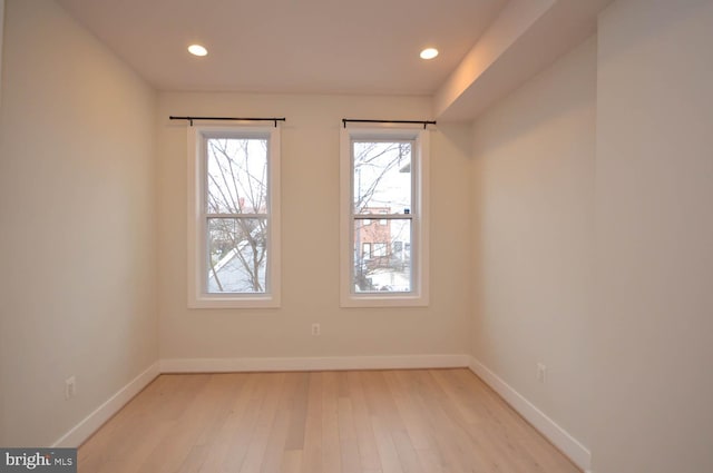 unfurnished room with recessed lighting, light wood-type flooring, and baseboards