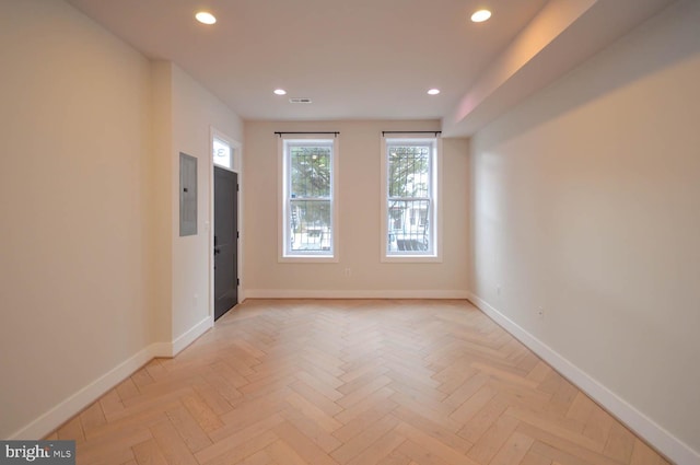 spare room with baseboards and recessed lighting