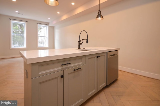 kitchen featuring recessed lighting, a sink, light countertops, dishwasher, and an island with sink