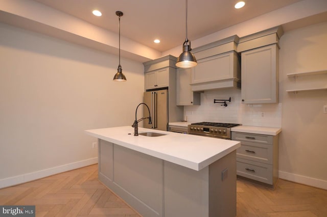 kitchen with appliances with stainless steel finishes, a sink, gray cabinetry, backsplash, and recessed lighting