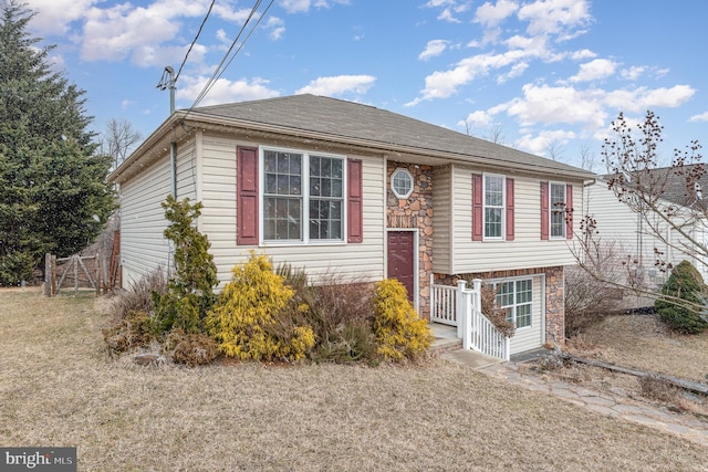 view of front of house featuring stone siding and a front yard