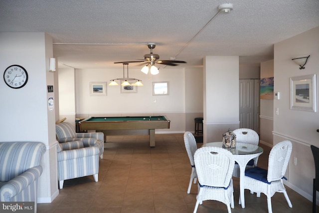 recreation room featuring a textured ceiling, dark tile patterned flooring, billiards, a ceiling fan, and baseboards