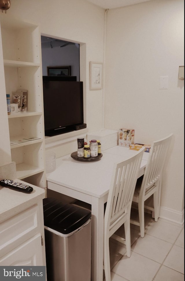 dining space featuring light tile patterned floors and baseboards