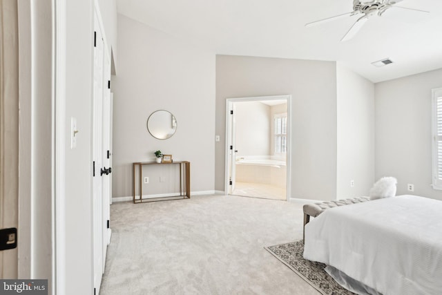 bedroom with light colored carpet, visible vents, baseboards, and ensuite bathroom