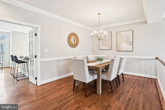 dining space featuring baseboards, ornamental molding, and dark wood-type flooring