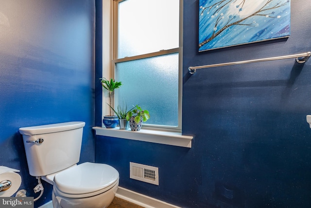 bathroom featuring toilet and visible vents