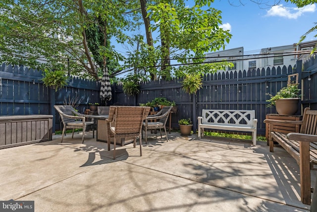 view of patio with outdoor dining area and fence private yard