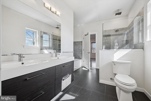 full bathroom with a tile shower, a sink, and tile patterned floors