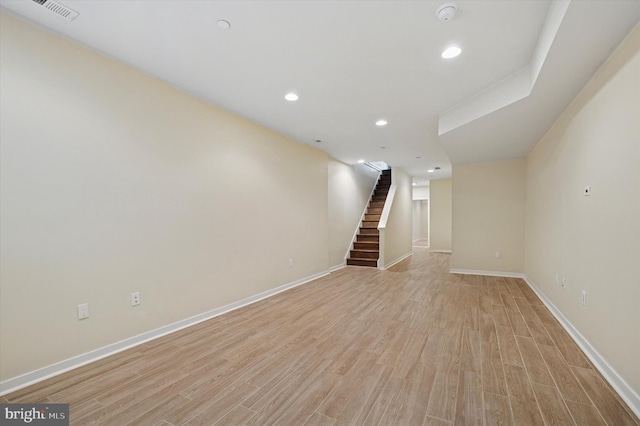 interior space featuring recessed lighting, light wood-style flooring, baseboards, and stairs