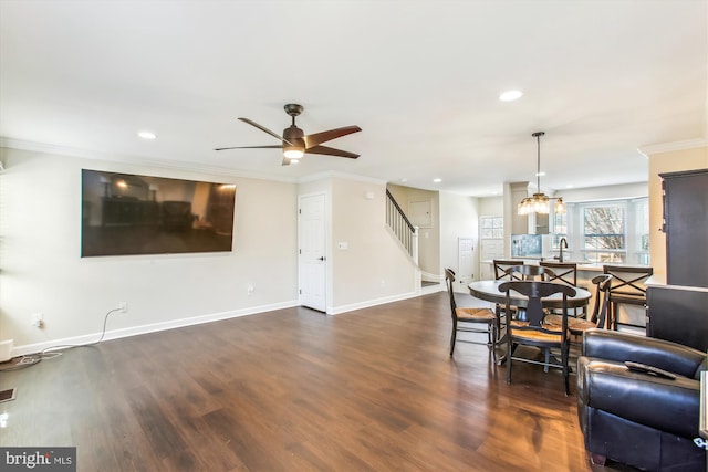 living area with baseboards, wood finished floors, stairs, crown molding, and recessed lighting