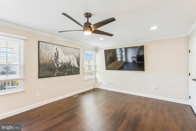 unfurnished room featuring baseboards, crown molding, and wood finished floors