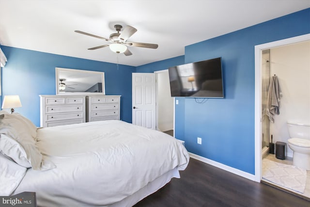 bedroom featuring dark wood-style flooring, ceiling fan, baseboards, and ensuite bathroom