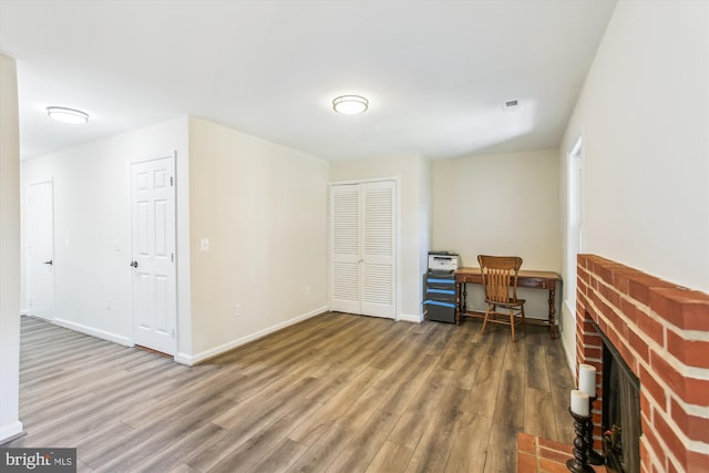 office area with visible vents, baseboards, and wood finished floors