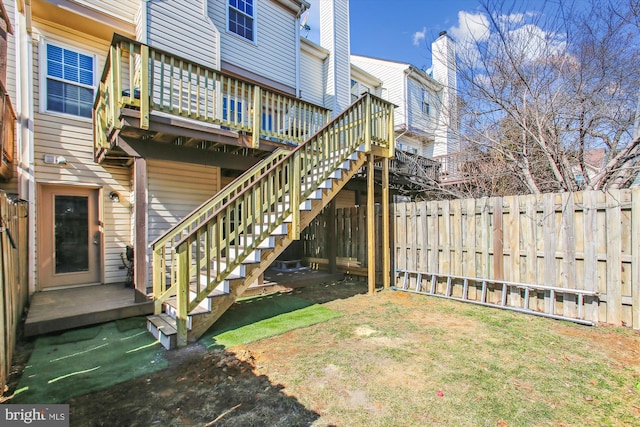 view of yard with stairs, fence, and a wooden deck