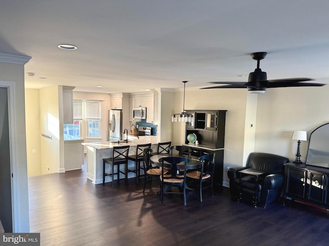 dining area with baseboards and dark wood-type flooring