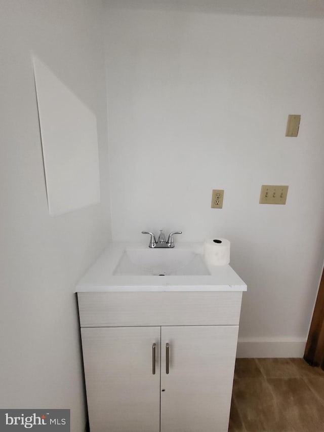 bathroom with vanity and baseboards