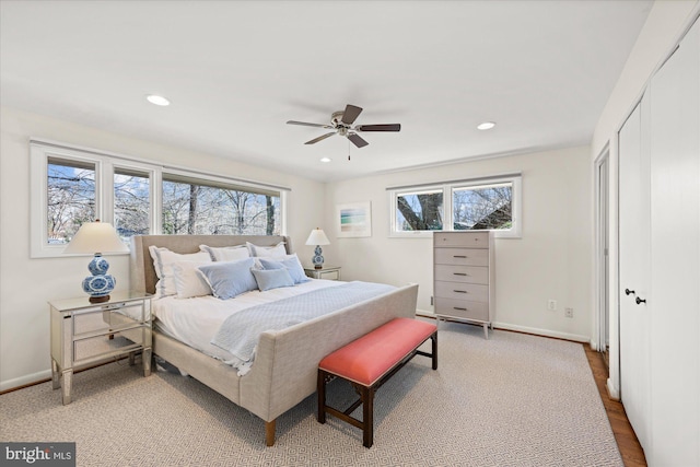 bedroom featuring multiple windows, recessed lighting, a ceiling fan, and baseboards