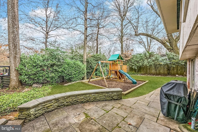 view of jungle gym with a fenced backyard, a yard, and a patio