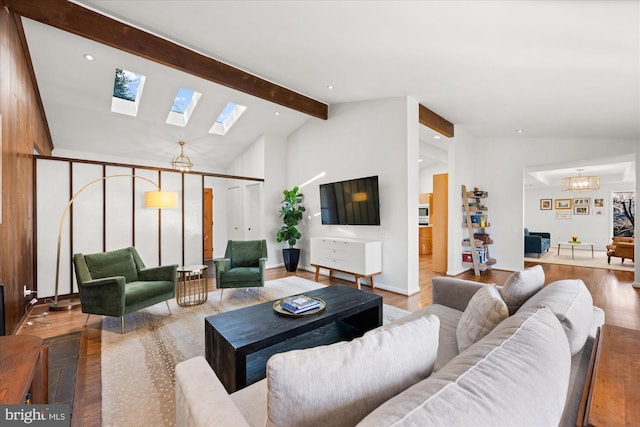 living area with a skylight, a notable chandelier, high vaulted ceiling, beamed ceiling, and parquet flooring