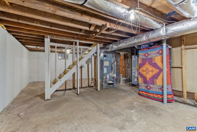 unfinished below grade area featuring heating unit, water heater, and stairs