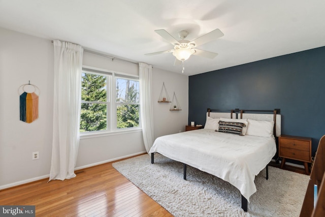 bedroom featuring hardwood / wood-style flooring, baseboards, and a ceiling fan