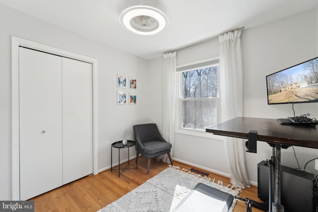 living area with light wood finished floors and baseboards