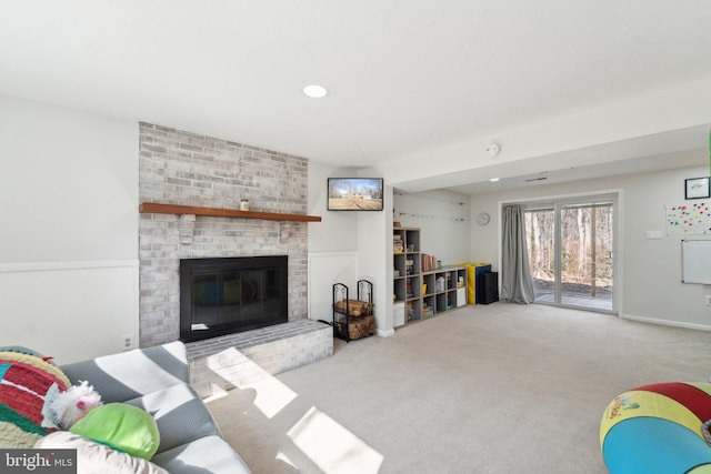 carpeted living area with a fireplace and recessed lighting