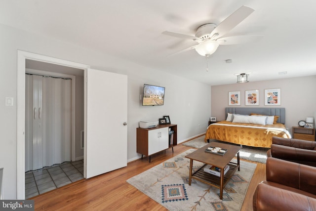 bedroom with light wood finished floors and baseboards