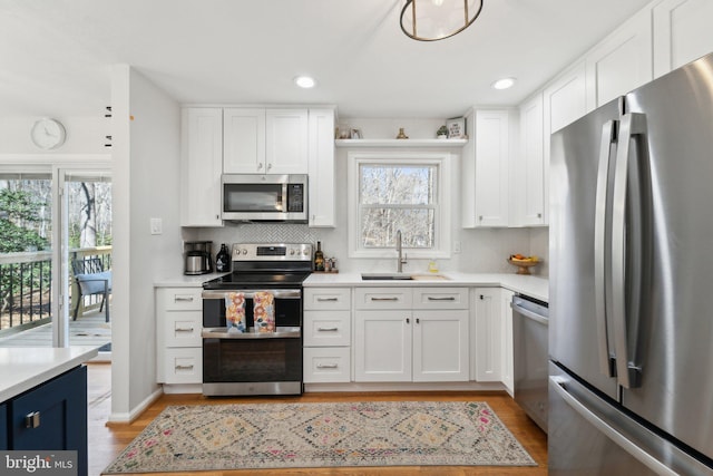 kitchen with light countertops, appliances with stainless steel finishes, and a sink