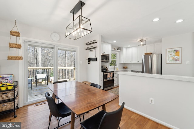 dining room with light wood-style flooring, visible vents, and recessed lighting